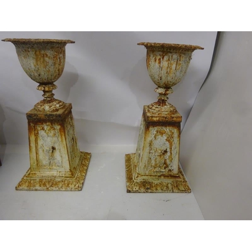 243 - A very good pair of antique cast iron garden urns of tulip shape and raised on tall tapered pedestal... 