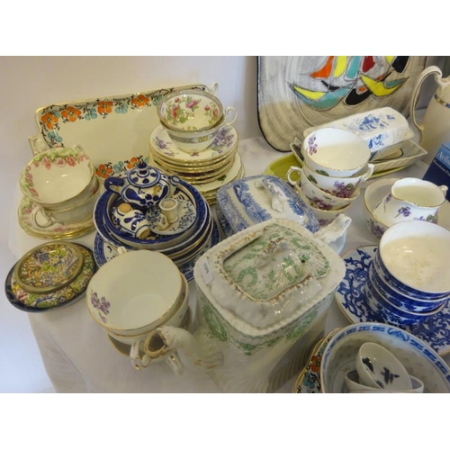 25 - Three shelves of chinaware.