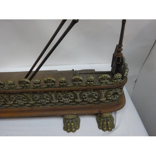 253 - A very good antique steel and brass fender complete with stands and irons. W. 112cm.