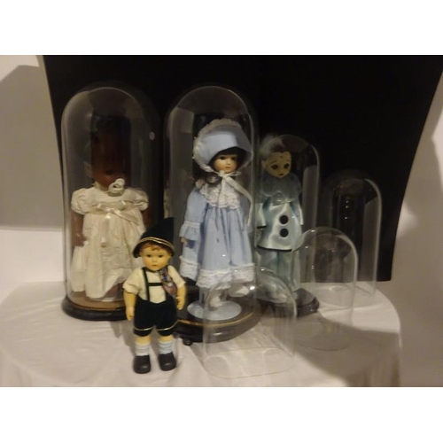 258 - A collection of dolls under old glass domes together with two small domes.