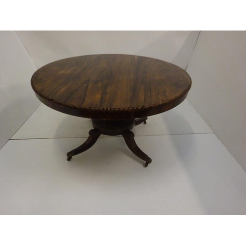 287 - A Regency rosewood circular dining table raised on turned column platform base and 4 splay legs with... 