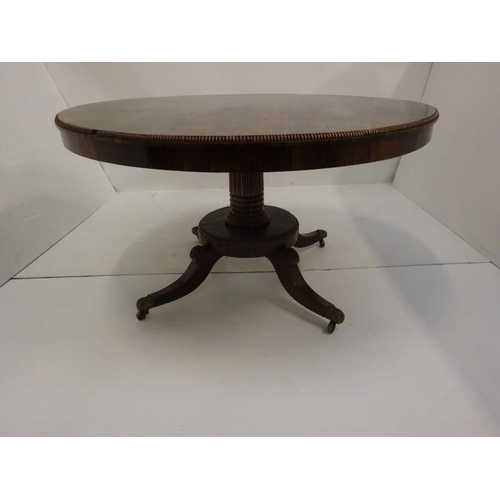 287 - A Regency rosewood circular dining table raised on turned column platform base and 4 splay legs with... 