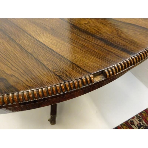 287 - A Regency rosewood circular dining table raised on turned column platform base and 4 splay legs with... 