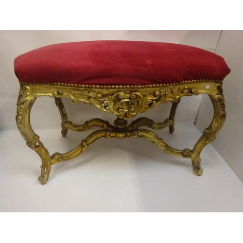 291 - Large gilt framed seat raised on shaped legs and cross stretcher with urn finial. W. 112cm, H. 70cm,... 