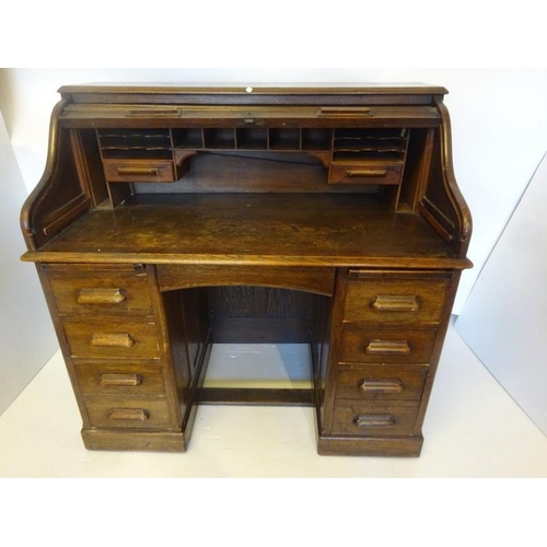 305 - Antique oak roll top writing desk fitted with drawers and pull out writing slides. Width 120cm.