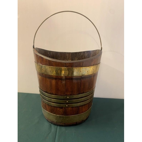 315 - Good antique mahogany and brass banded turf bucket with swing handle. H. 30cm, W. 30cm.