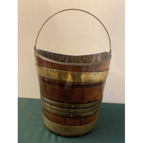 315 - Good antique mahogany and brass banded turf bucket with swing handle. H. 30cm, W. 30cm.