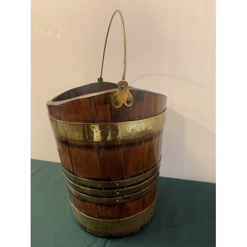 315 - Good antique mahogany and brass banded turf bucket with swing handle. H. 30cm, W. 30cm.