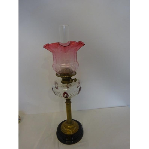 322 - Antique brass column oil lamp having clear glass bowl with red glass decoration and red glass shade ... 