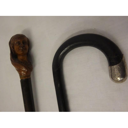 332 - Two old walking sticks, one with carved head decoration.