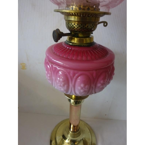 359 - Victorian brass oil lamp with quilted bowl and red shade.