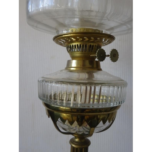 361 - A tall decorative brass column oil lamp with clear glass bowl and etch shade.