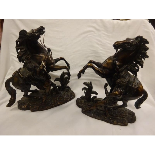 367 - A pair of antique bronze marley horses and horsemen, signed. H. 40cm.