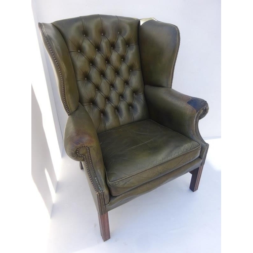 371 - Old leather wing back library chair raised on square legs with cross stretchers. One arm worn (see p... 