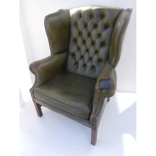 371 - Old leather wing back library chair raised on square legs with cross stretchers. One arm worn (see p... 