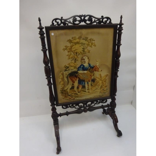 55 - A large Victorian mahogany fire screen with embroidered panel. H. 140cm W. 80cm approx.