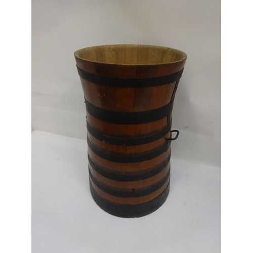 9 - Tall oak and metal banded barrel. H. 90cm, W. 55cm approx.