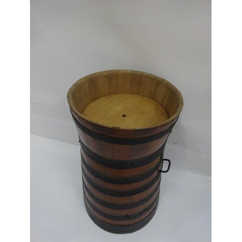 9 - Tall oak and metal banded barrel. H. 90cm, W. 55cm approx.