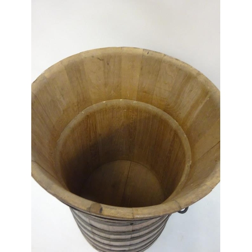 9 - Tall oak and metal banded barrel. H. 90cm, W. 55cm approx.