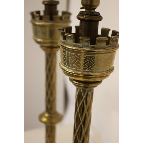 95 - A pair of antique tall brass candlesticks with Celtic design work, electrified. H. 70cm.