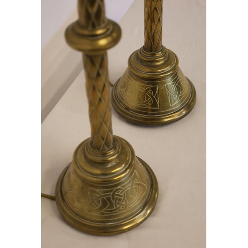 95 - A pair of antique tall brass candlesticks with Celtic design work, electrified. H. 70cm.