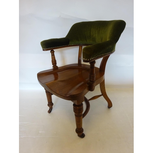 107 - A good antique mahogany desk or library chair having upholstered arms and back and raised on turned ... 