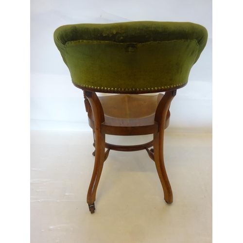 107 - A good antique mahogany desk or library chair having upholstered arms and back and raised on turned ... 