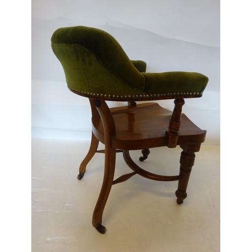 107 - A good antique mahogany desk or library chair having upholstered arms and back and raised on turned ... 