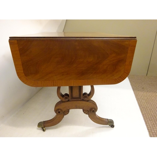 112 - A Cork Regency mahogany and satinwood banded sofa table fitted with real and dummy drawers and raise... 