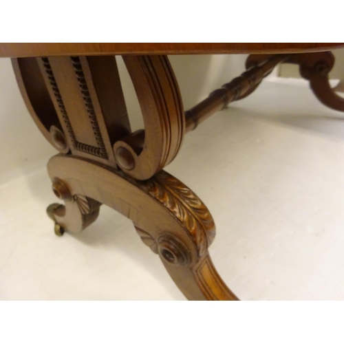 112 - A Cork Regency mahogany and satinwood banded sofa table fitted with real and dummy drawers and raise... 