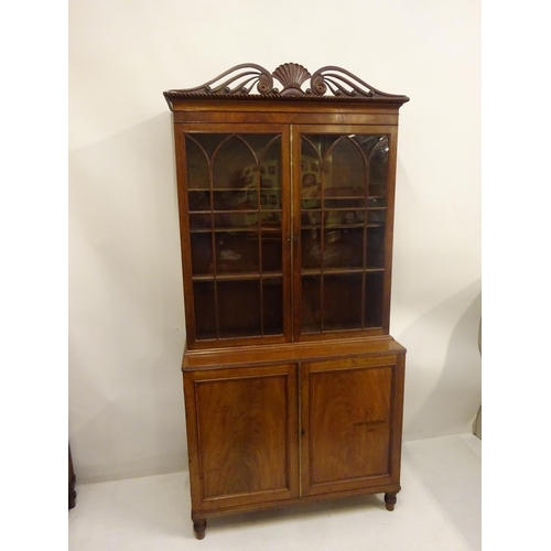 115 - A good antique mahogany Cork bookcase, the upper section having decorative cornice over two sectione... 