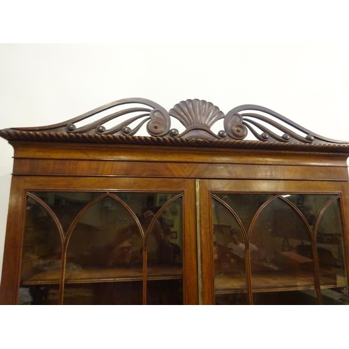 115 - A good antique mahogany Cork bookcase, the upper section having decorative cornice over two sectione... 