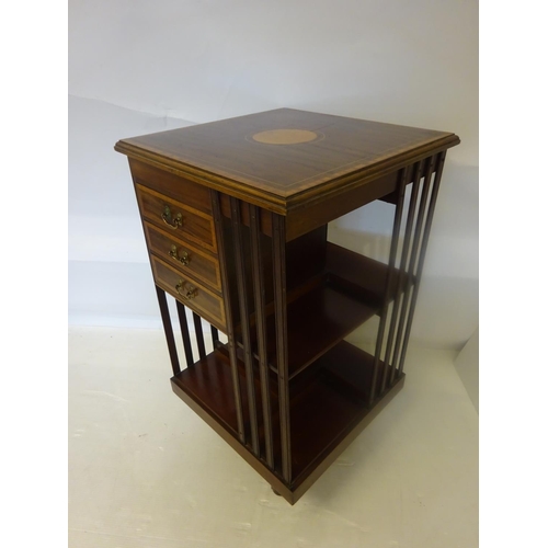 117 - Mahogany and satinwood inlaid revolving book stand, one section fitted with drawers.