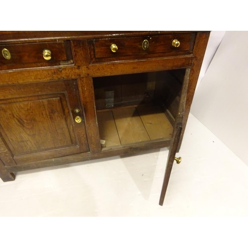 123 - A good 18th century oak court cupboard in three sections, the top section having plate rack with lat... 