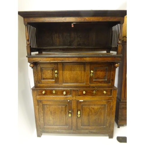 123 - A good 18th century oak court cupboard in three sections, the top section having plate rack with lat... 