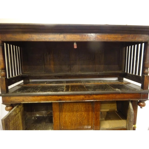 123 - A good 18th century oak court cupboard in three sections, the top section having plate rack with lat... 