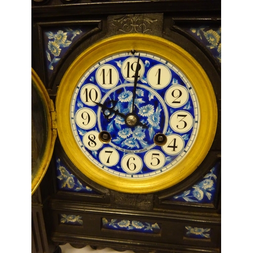 124 - Victorian ebonized cased mantle clock with blue porcelain dials and panels. Movement stamped.