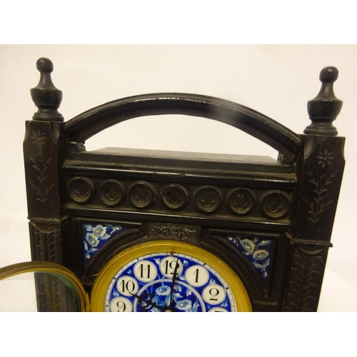 124 - Victorian ebonized cased mantle clock with blue porcelain dials and panels. Movement stamped.