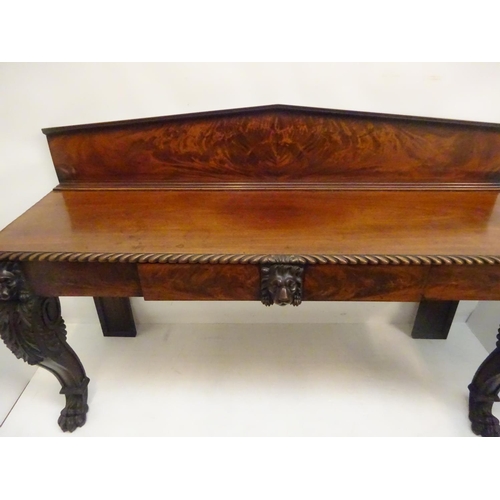 132 - A good Irish early 19th century mahogany server/side table, the top with shaped gallery and plate ra... 