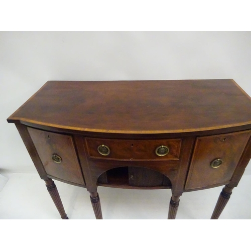 134 - A good Georgian mahogany and satinwood banded bow shaped sideboard fitted with drawers and tambour s... 