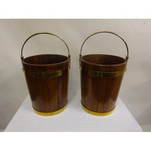 135 - A pair of Irish Georgian mahogany brass banded turf buckets with good carrying handles. H. 44cm, Dia... 