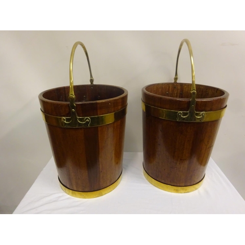 135 - A pair of Irish Georgian mahogany brass banded turf buckets with good carrying handles. H. 44cm, Dia... 