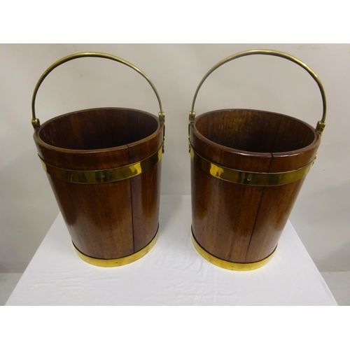 135 - A pair of Irish Georgian mahogany brass banded turf buckets with good carrying handles. H. 44cm, Dia... 