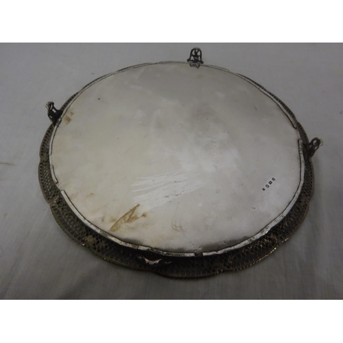 165 - A fine large English silver circular salver having decorative pierced border and raised on four feet... 