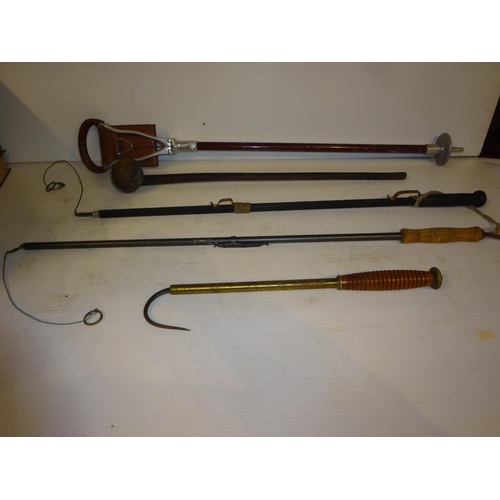 201 - A good old timber handled and brass fishing gaff together with a shouting stick, club and two snares... 