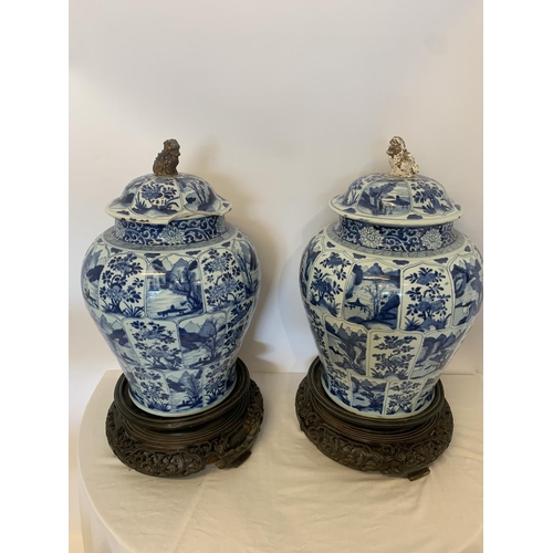 215 - A good pair of large antique Chinese blue and white baluster jars and covers, painted throughout wit... 