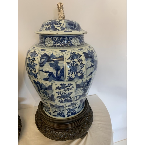 215 - A good pair of large antique Chinese blue and white baluster jars and covers, painted throughout wit... 