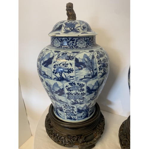 215 - A good pair of large antique Chinese blue and white baluster jars and covers, painted throughout wit... 