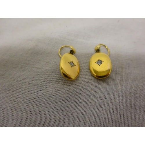 226 - Pair of neat size gold earrings with diamond studs.