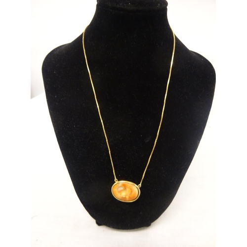 229 - Gold shell pendant.